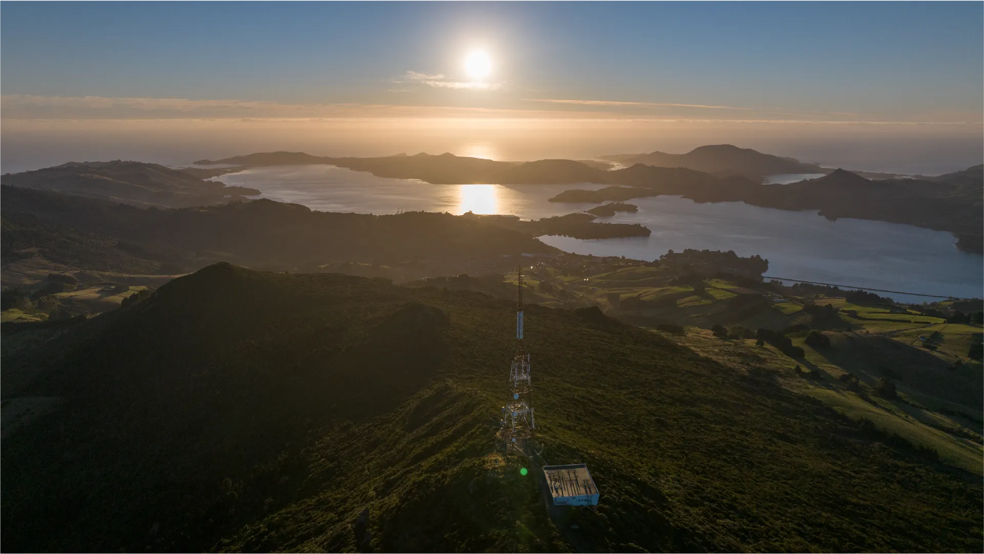 Dunedin, When the Sun Rises from the Mountain and Ocean Aerial footage of Dunedin captured at sunrise across a full year of production, from Larnach Castle and Mt Cargill to the university campus and harbour.